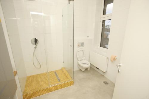 a bathroom with a shower with a toilet at TRAMVAJ Apartments in Belgrade
