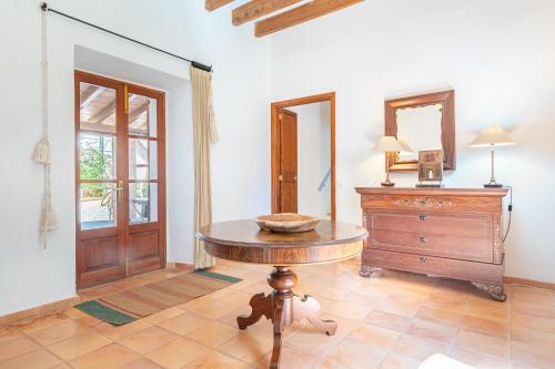 a room with a table and a dresser and a mirror at Casa Can Pauma in Caʼs Concos