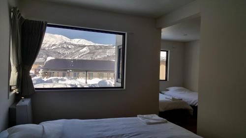 Postel nebo postele na pokoji v ubytování Uchimaru Hakuba