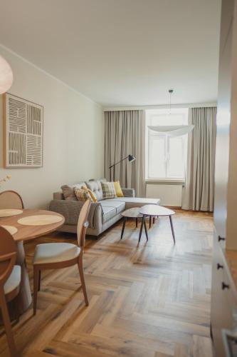 a living room with a couch and a table at Apartamenty Rynek 12 in Tarnów
