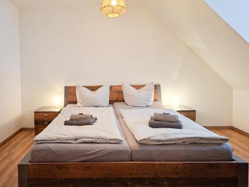 a bedroom with a large bed with two pillows on it at Haus Felsenpost in Stadt Wehlen