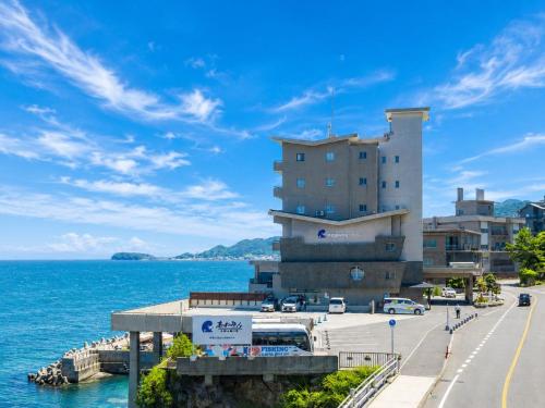 a large building next to the water with a street at Awakan in Sumoto