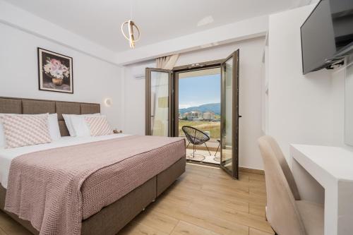 a bedroom with a bed and a sliding glass door at Villa Lux Stana in Zakynthos