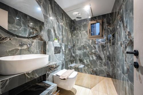 a bathroom with a sink and a toilet at Villa Lux Stana in Zakynthos