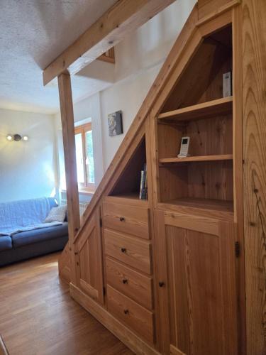 a large wooden cabinet in a living room at L'Atelier du Temps - Moline Paradiso in Cogne