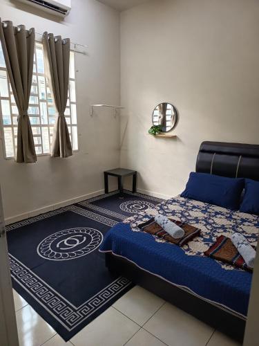 a bedroom with a blue bed and a mirror at Lynn Homestay Alor Setar in Alor Setar