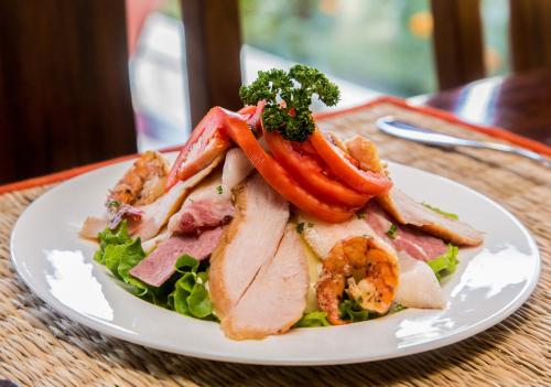 a plate of food with meat and vegetables on a table at Traditional Comfort Boutique Hotel in Kathmandu