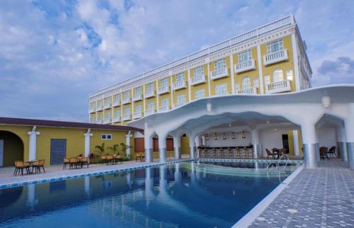 a hotel with a swimming pool in front of a building at HOTEL VAN GOGH in Candon