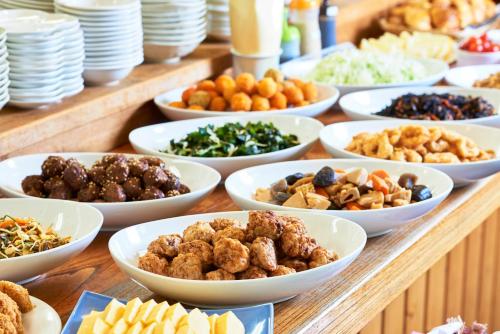 a buffet of different types of food on a table at Hotel Select Inn Hachinohe Chuo in Hachinohe