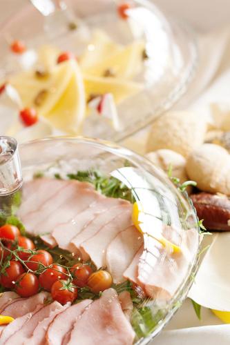 a plate of food with meat and vegetables on a table at Hotel Poniatowski in Radom