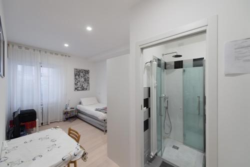 a bathroom with a shower and a room with a bed at B&B Rosa Blu in Como