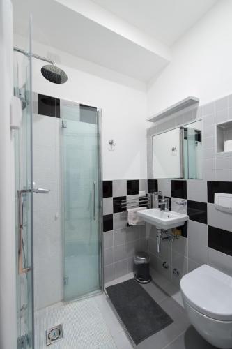 a bathroom with a shower and a toilet and a sink at B&B Rosa Blu in Como