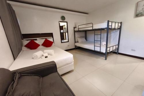 a bedroom with a bed and a bunk bed at Ecoland 88 Apartelle and Suite near SM Davao in Davao City