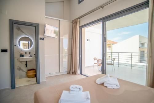 a bedroom with a bed and a view of the ocean at Evaeri Suites in Mytikas