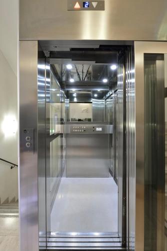 a silver refrigerator with its door open in a room at Casa I Cappuccini in Rome
