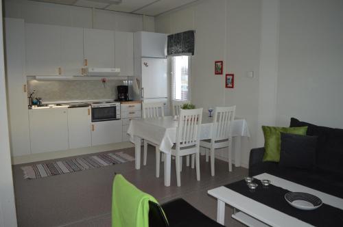 a kitchen and a living room with a table and a couch at Vreta Kloster Golfklubb in Ljungsbro