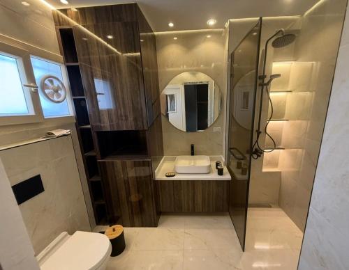 a bathroom with a shower and a toilet and a sink at Alshrooq Village 97 in Borg El Arab