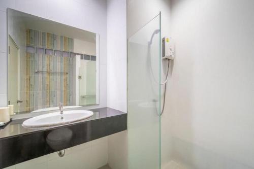 a bathroom with a sink and a mirror at Belleville hotel in Phetchabun