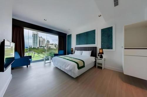 a hotel room with a bed and a large window at Read River in Anping
