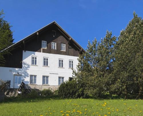 a large white building with a black roof at Pod Maliníkem in Bedřichov