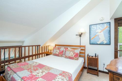 a bedroom with a bed with a wooden frame at Manitou Lodge 8 by Alpine Lodging Telluride in Telluride
