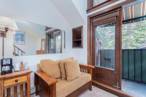 a living room with a couch and a window at Manitou Lodge 8 by Alpine Lodging Telluride in Telluride