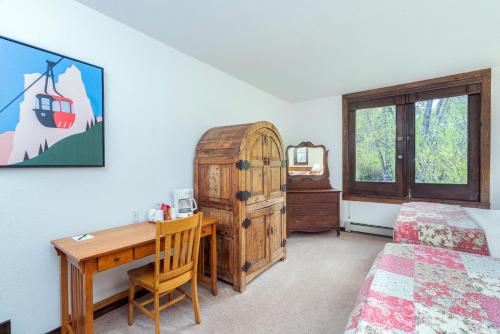 a bedroom with a desk and a bed at Manitou Lodge 3 by Alpine Lodging Telluride in Telluride
