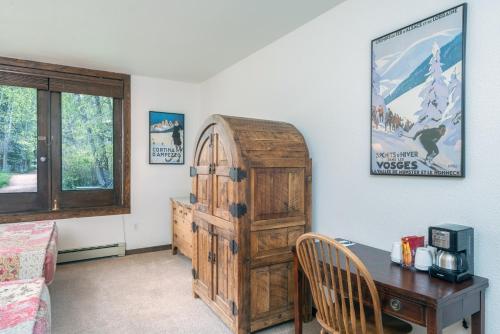 a room with a desk and a wooden cabinet at Manitou Lodge 2 by Alpine Lodging Telluride in Telluride