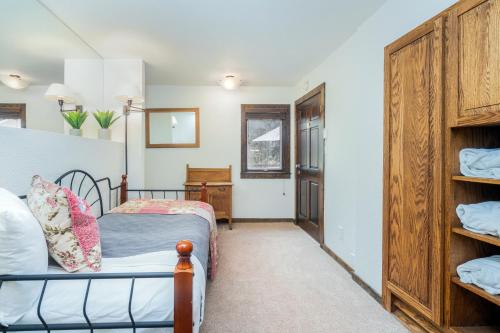 a bedroom with a bed and a closet at Manitou Lodge 4 by Alpine Lodging Telluride in Telluride