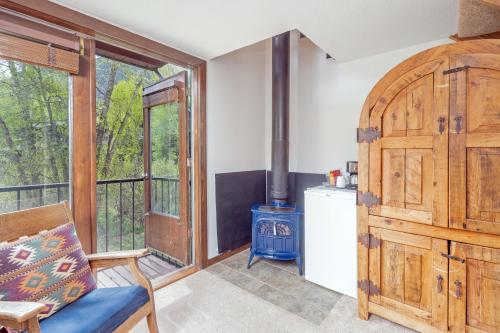 a room with a fireplace and a wood stove at Manitou Lodge 6 by Alpine Lodging Telluride in Telluride