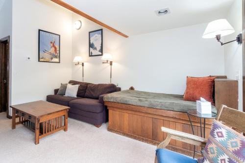 a living room with a bed and a couch at Manitou Lodge 6 by Alpine Lodging Telluride in Telluride