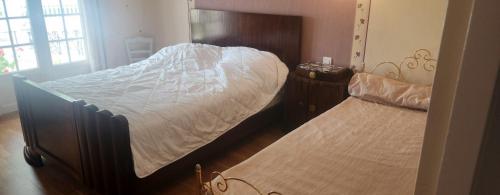 a bedroom with two beds and a bedskirts at La Genetouze in La Genétouze