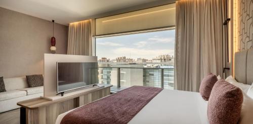 a hotel room with a bed and a large window at Ilunion Atrium in Madrid