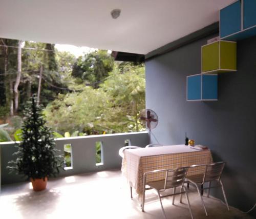 a room with a table and a christmas tree on a balcony at Green Peace Sungai Lembing in Sungai Lembing