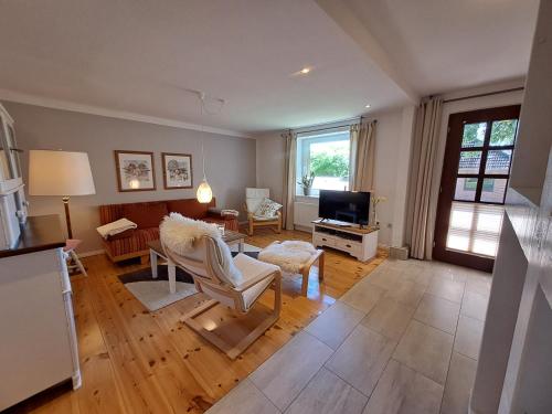 a living room with a couch and a tv at Ferienwohnung Rahn in Freienwill