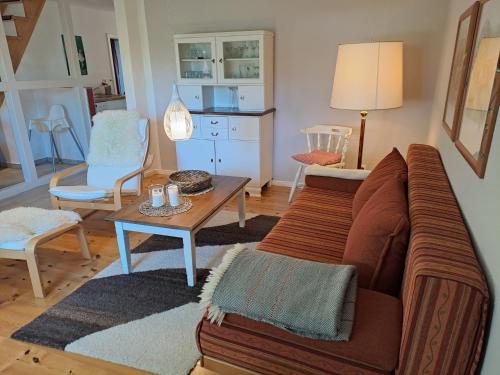 a living room with a couch and a table at Ferienwohnung Rahn in Freienwill