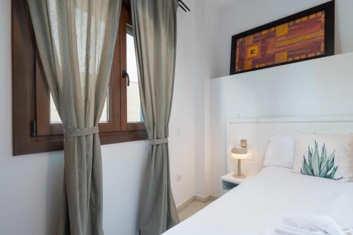 a bedroom with a bed and a window at Lux Sevilla Apartment Piscina in Bormujos