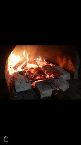 a fire in a brick oven with flames in it at Complex Ristanite in Elena