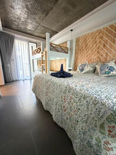 a bedroom with a large bed and a loft at Ozonizia Family Suites Mai Khao Phuket Yacht Haven in Phuket