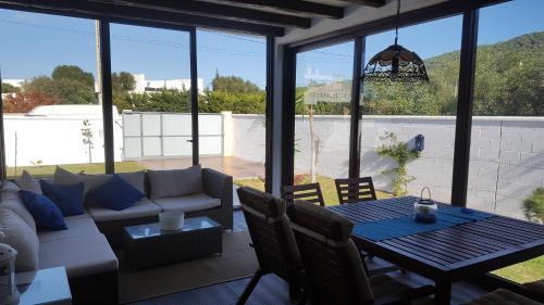 a living room with a couch and a table at Barlovento Tres, Los Caños in Los Caños de Meca