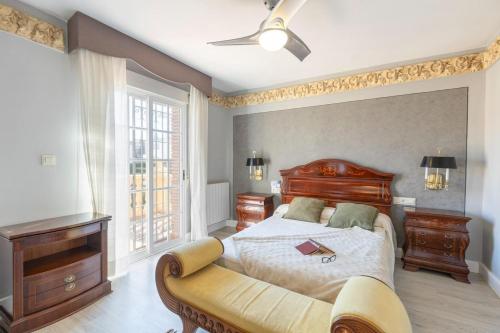 a bedroom with a bed and a dresser and a window at Cypress House La Zubia in La Zubia