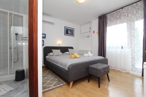 a bedroom with a bed and a shower at Rooms and Studio Salvi in Rovinj