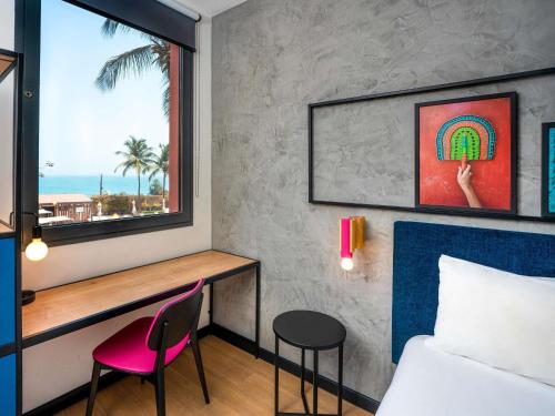 a bedroom with a bed and a window and a desk at Ibis Styles Dakar in Dakar