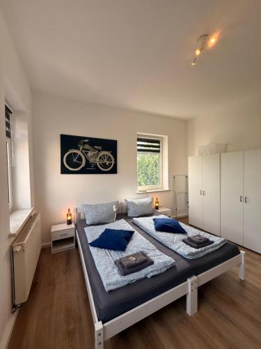 a bedroom with a large bed with blue pillows at Stay&Work Döbeln - Hermsdorfer Straße in Döbeln
