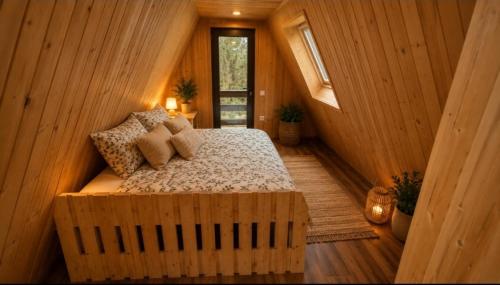 a bedroom with a bed in a wooden cabin at Koča Rakitna Forest Chalet with Sauna in Preserje