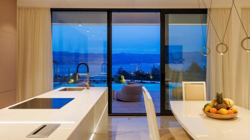 a kitchen with a counter with a bowl of fruit at Villa Sun dance by Villas Guide in Vrbnik