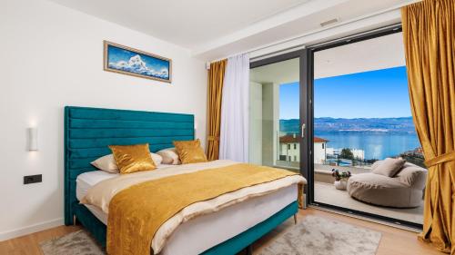 a bedroom with a bed and a large window at Villa Sun dance by Villas Guide in Vrbnik