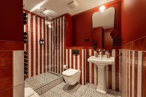 a bathroom with a toilet and a sink at TWENTYSEVEN Boutique in Budapest