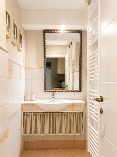 a bathroom with a sink and a mirror at Apartment Sulle scale in Piran