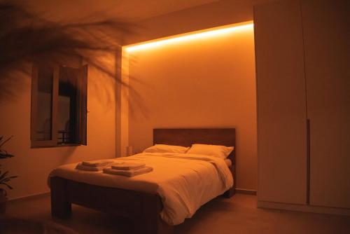a bedroom with a bed with a light on it at Central cozy studio in Agios Nikolaos
